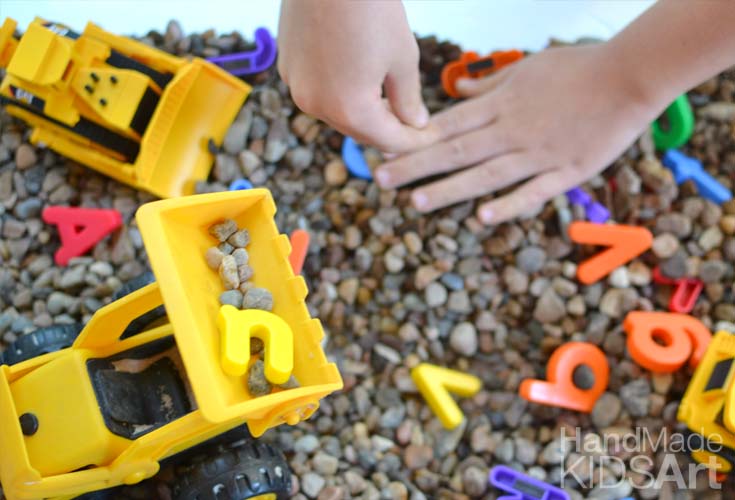 Sensory play with alphabet letters and construction trucks