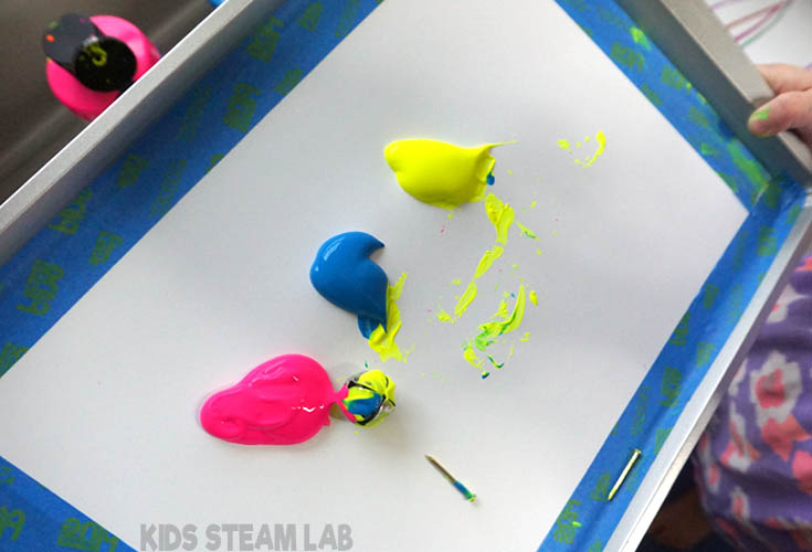 Use the magnet to move the objects around in the paint.